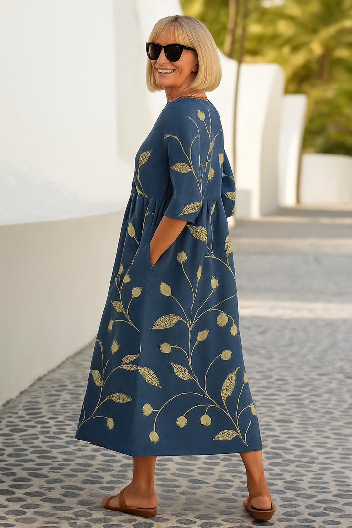 Navy midi dress with gold botanical print, three-quarter sleeves, gathered waist