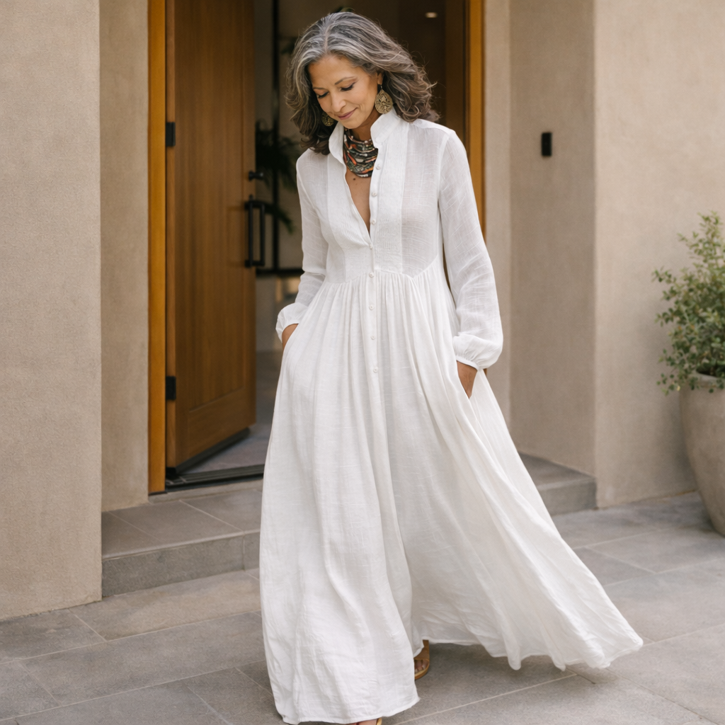 White button-front maxi dress with long sleeves, gathered waist and full flowing skirt