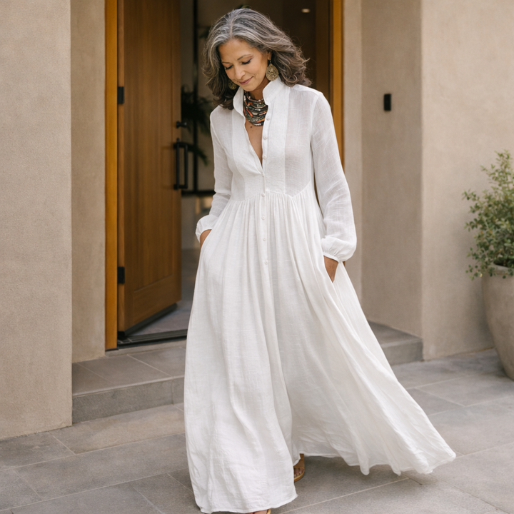 White button-front maxi dress with long sleeves, gathered waist and full flowing skirt