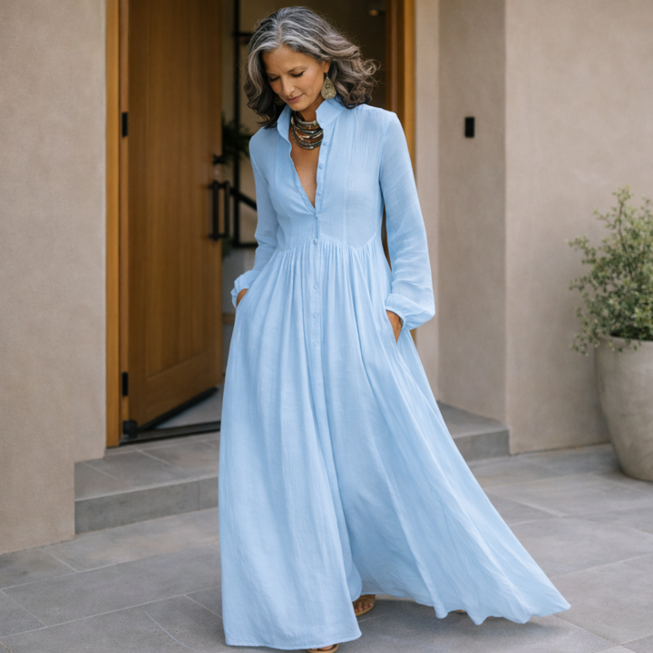 Light blue maxi dress with V-neck button-front, long sleeves and flowing gathered skirt