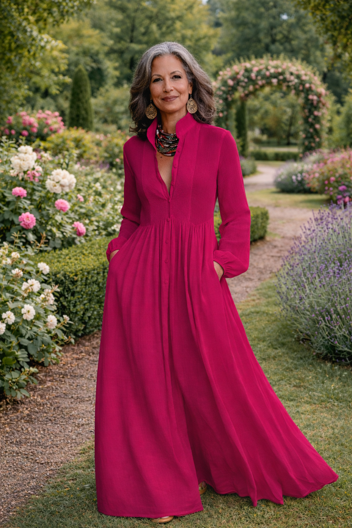 Dark pink button-front maxi dress with long sleeves, pleated bodice, and full hem