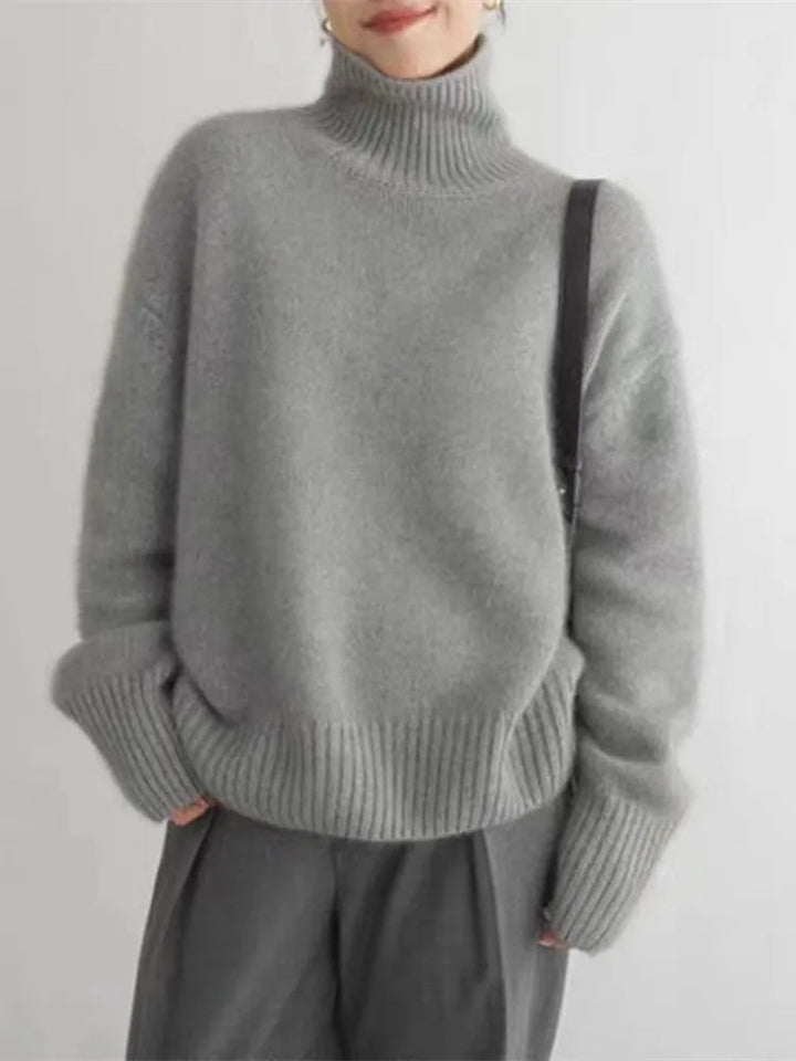 Gray oversized turtleneck sweater with ribbed collar and cuffs