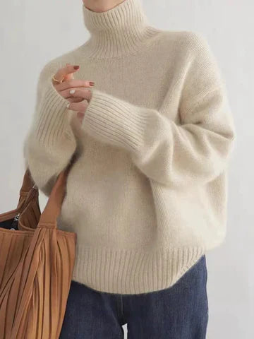 Beige oversized turtleneck sweater with ribbed cuffs and hem