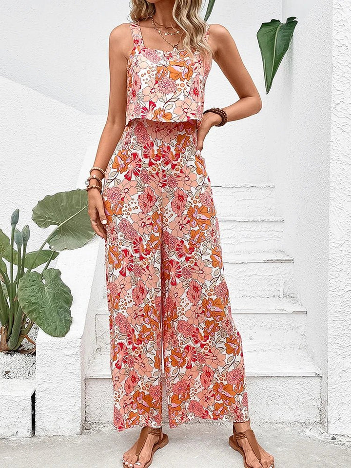 Apricot floral wide-leg jumpsuit with smocked waist and flowy wide pants.
