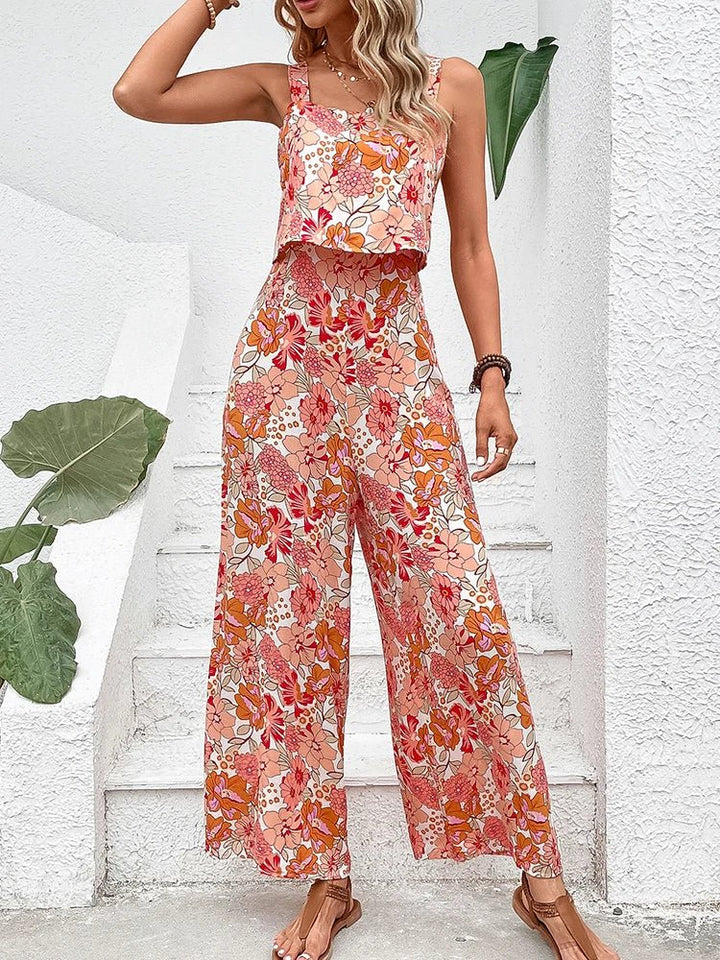 Apricot floral wide-leg jumpsuit with square neckline and spaghetti straps.