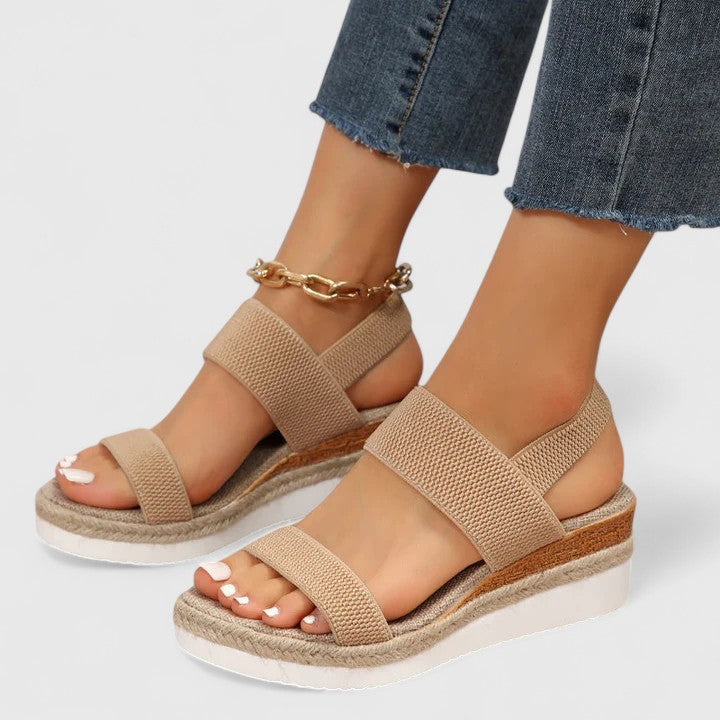 Women’s orthopedic sandals with arch support, tan two-strap design and gold ankle chain.