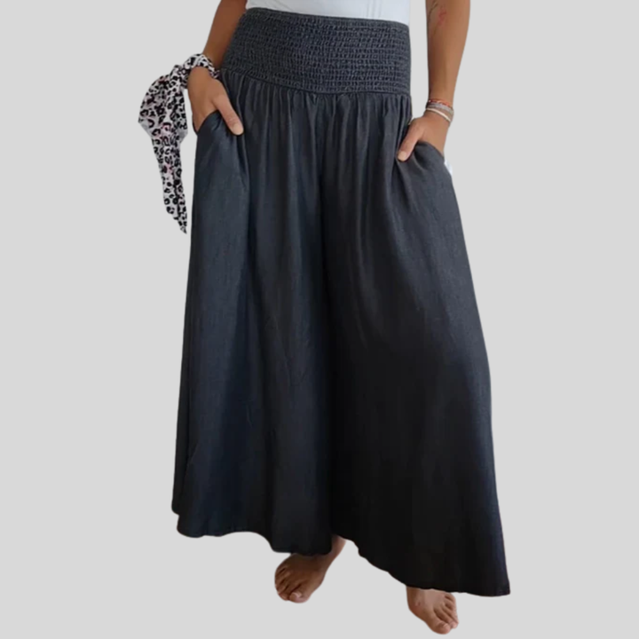 Dark blue flowy wide pants with elastic smocked waistband and gathered skirt