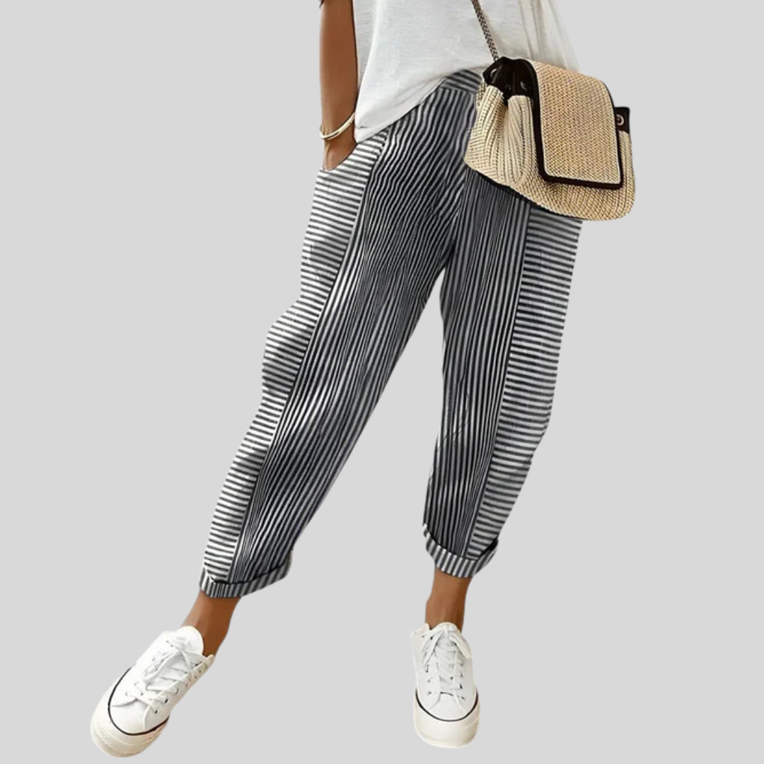 Black striped relaxed pants with elastic cuffs and pleated drape.