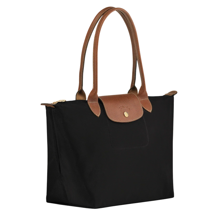 Medium nylon tote bag with black body, brown handles, and top flap with gold snap