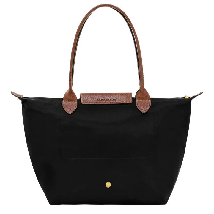 Medium nylon tote bag front view with black fabric, brown handle accents, and gold snap