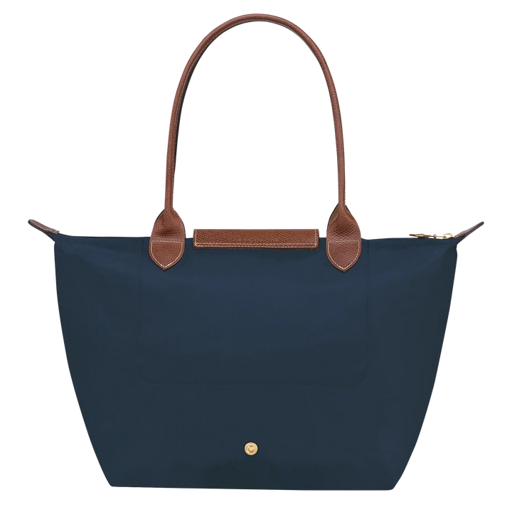 Navy medium nylon tote with brown leather handles and back snap pocket