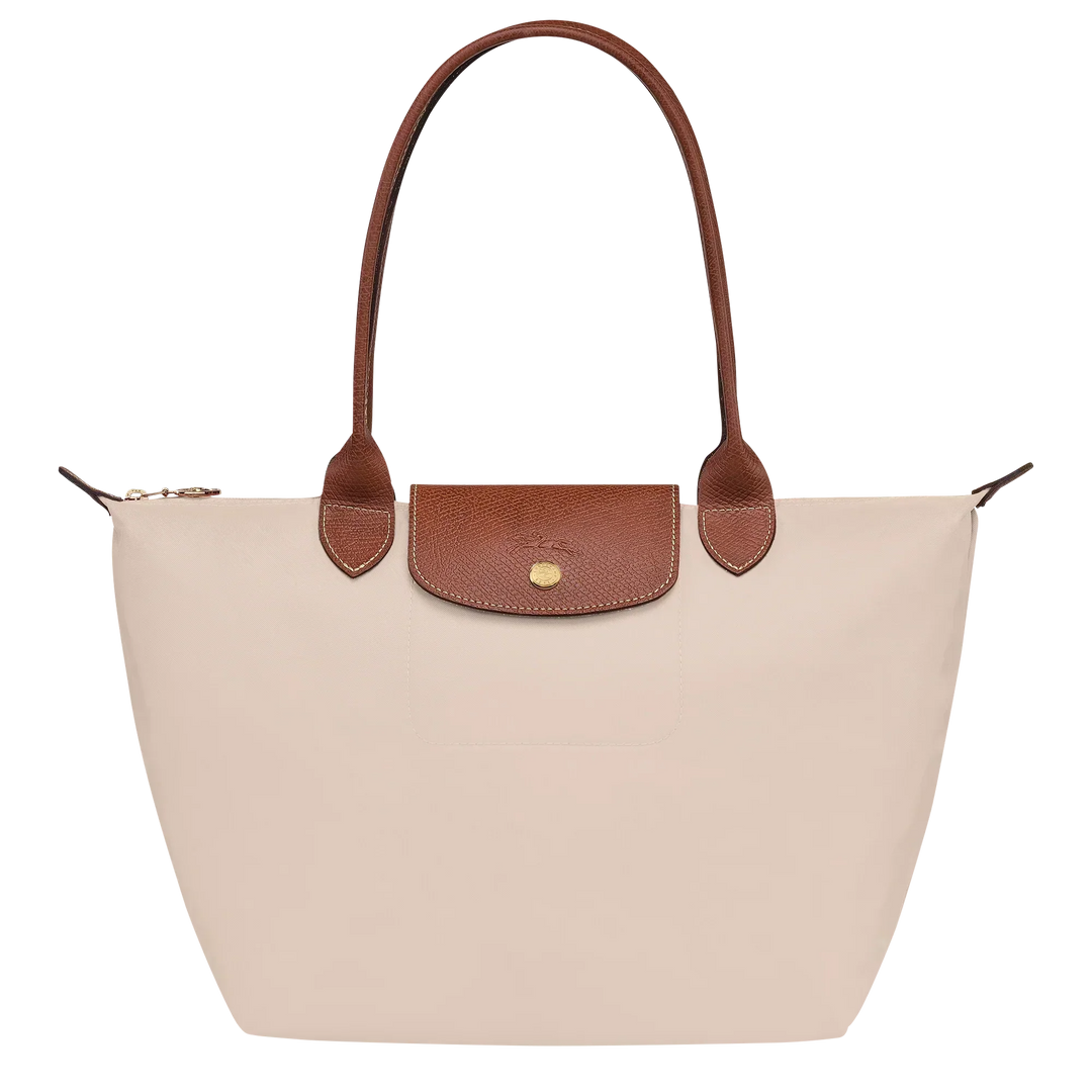 Cream canvas medium tote bag with brown leather handles and front flap pocket
