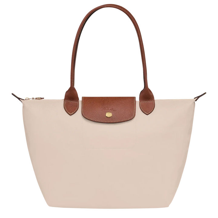 Cream canvas medium tote bag with brown leather handles and front flap pocket