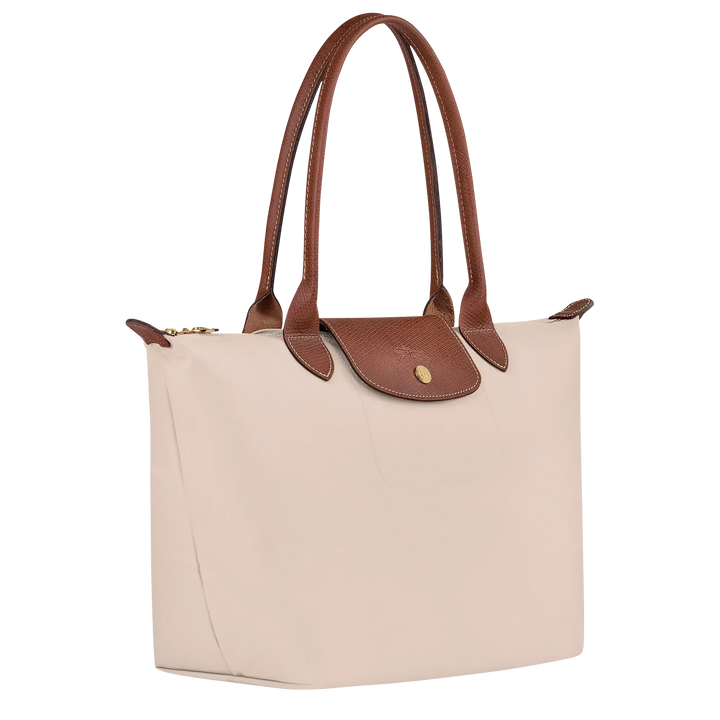 Cream canvas medium tote bag with brown leather handles and side flap pocket
