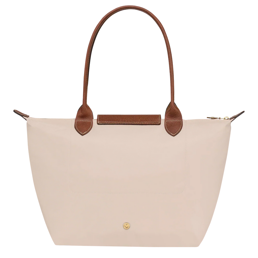 Cream canvas medium tote bag with brown leather trim and front pocket detail