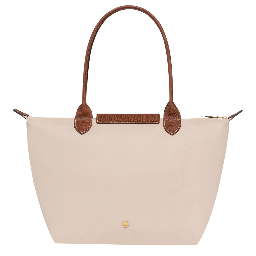 Cream canvas medium tote bag with brown leather trim and front pocket detail