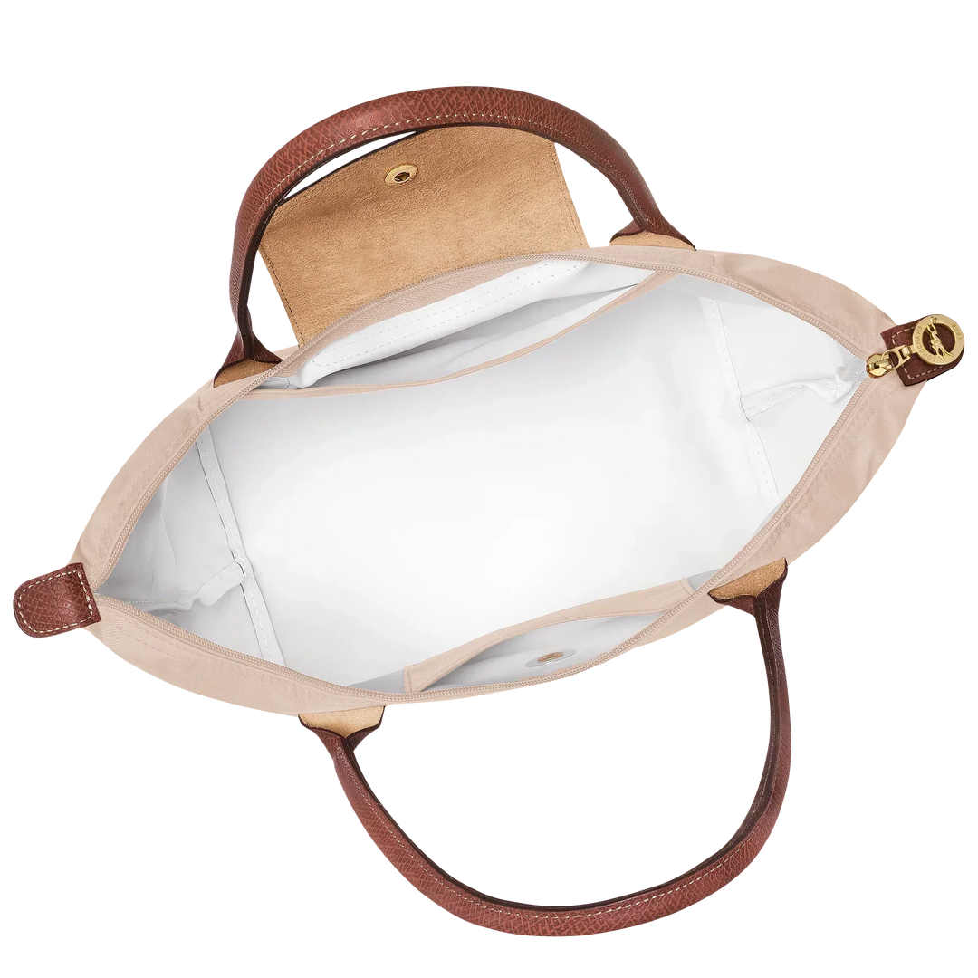 Open medium tote bag with cream lining, interior pocket, and brown top trim