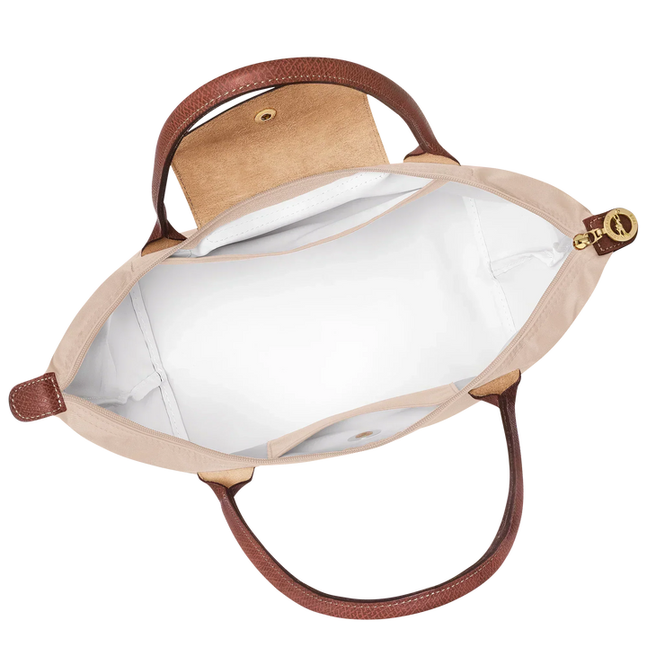 Open medium tote bag with cream lining, interior pocket, and brown top trim