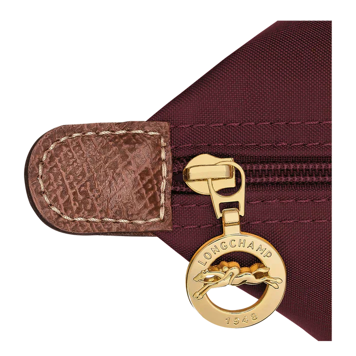 Burgundy nylon tote bag zipper pull with gold Longchamp charm