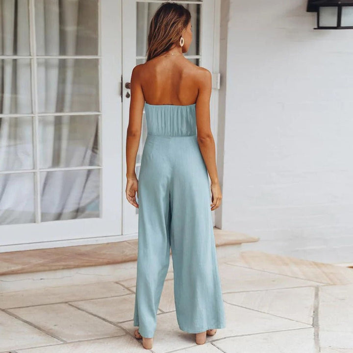 Back view of light blue strapless tie-waist jumpsuit with smocked back panel