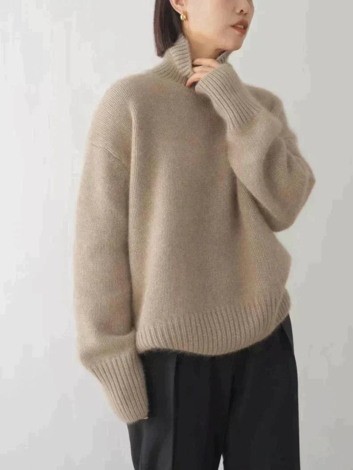 Beige oversized turtleneck sweater with ribbed hem and wide back silhouette