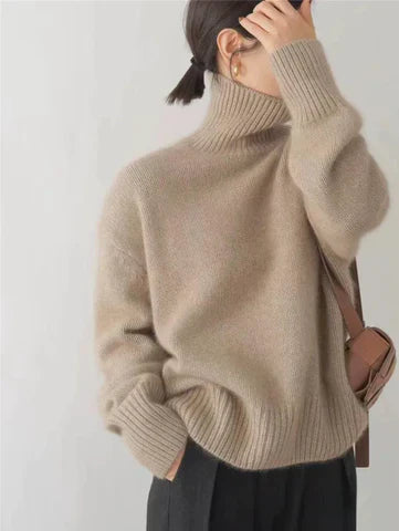 Beige oversized turtleneck sweater with ribbed collar and cuffs
