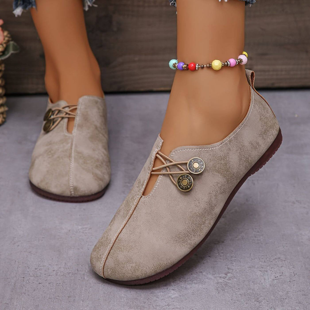 Light brown slip-on flats with lace-up vamp and two round button details
