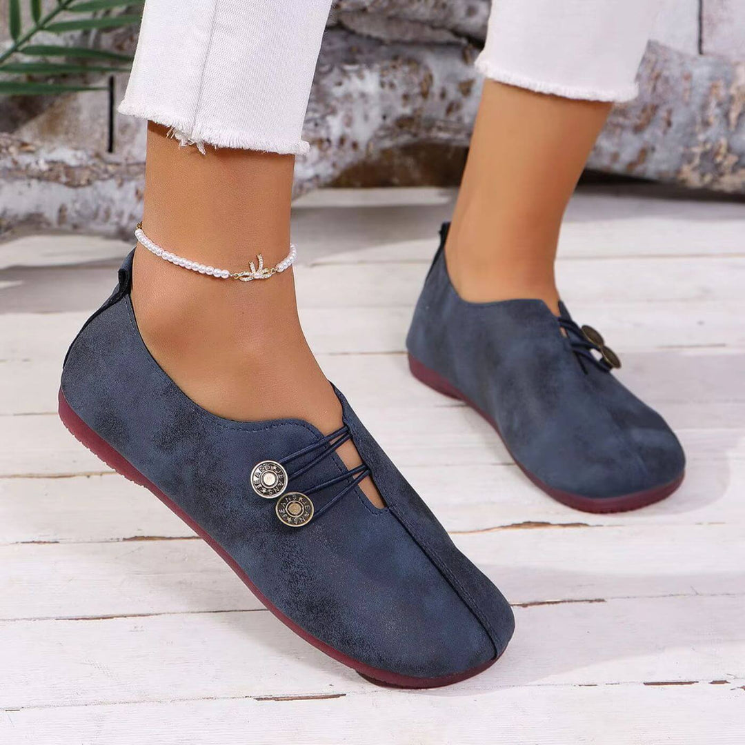 Navy slip-on flats with button-detail lace-up front and flat rubber sole