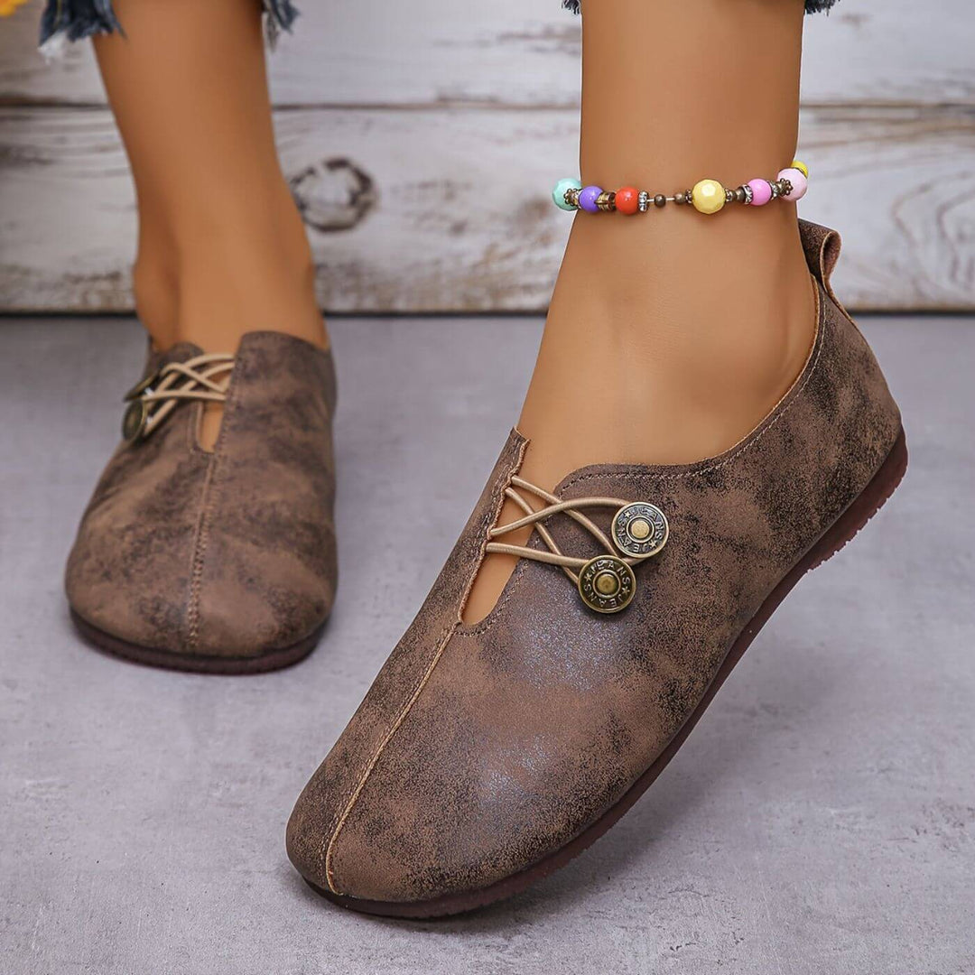 Dark brown slip-on flats with lace-up vamp and two round button details