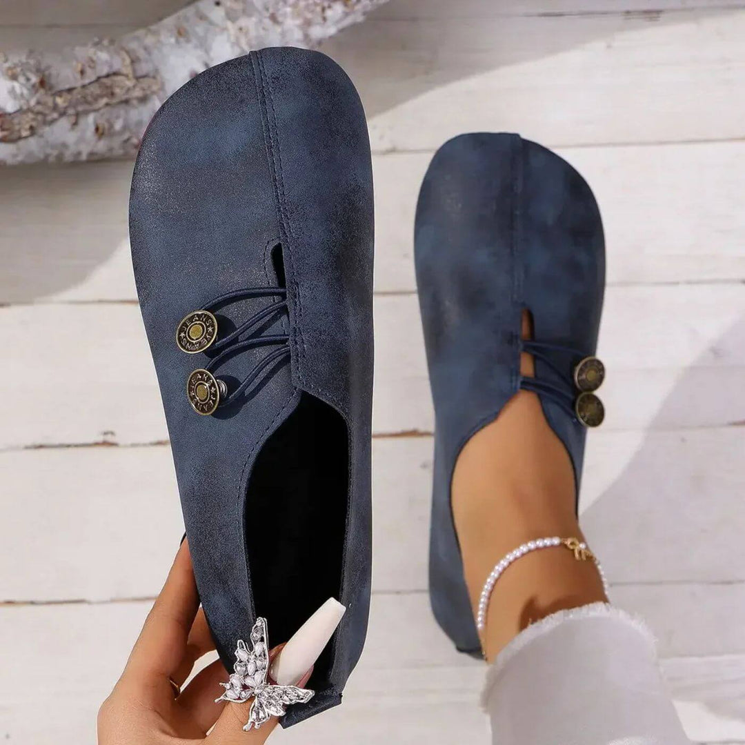 Navy slip-on flats with lace-up front and two round button accents