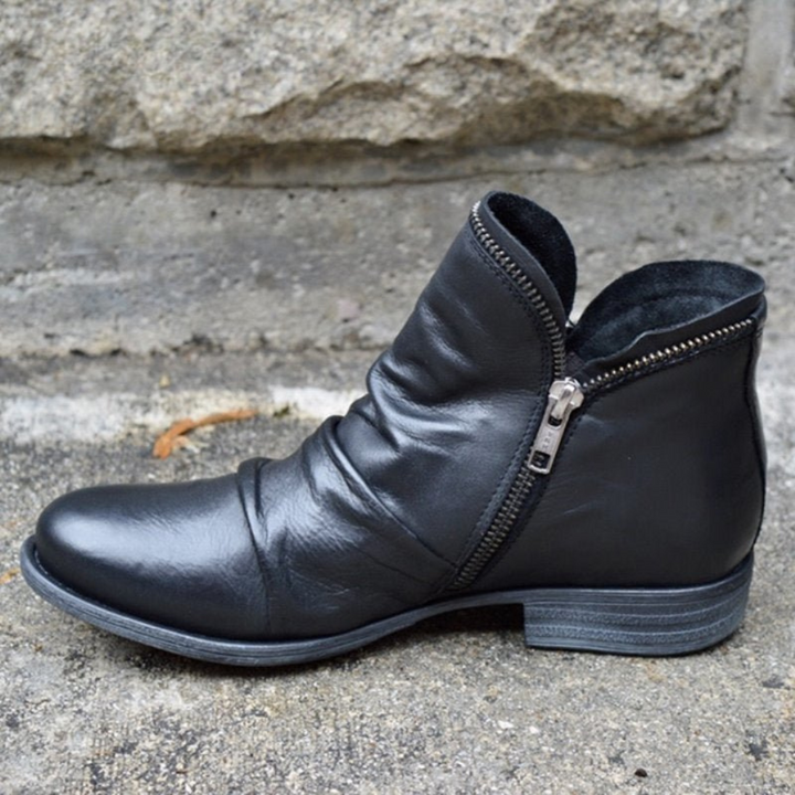 Black side-zip ankle boots with low stacked heel and silver zipper hardware