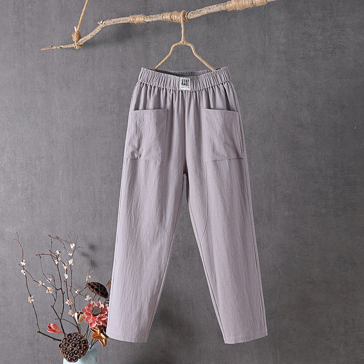 Gray relaxed pocket pants with elastic waistband and two side patch pockets.