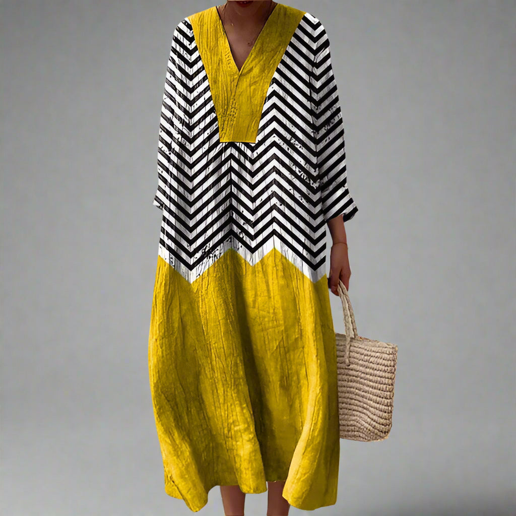 Geometric dress with black-and-white chevron top and mustard yellow V-neck skirt panels