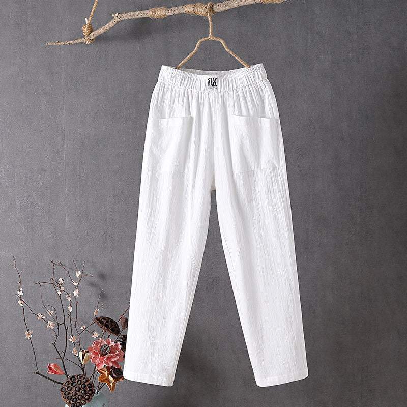 White relaxed pocket pants with elastic waistband and two side patch pockets.