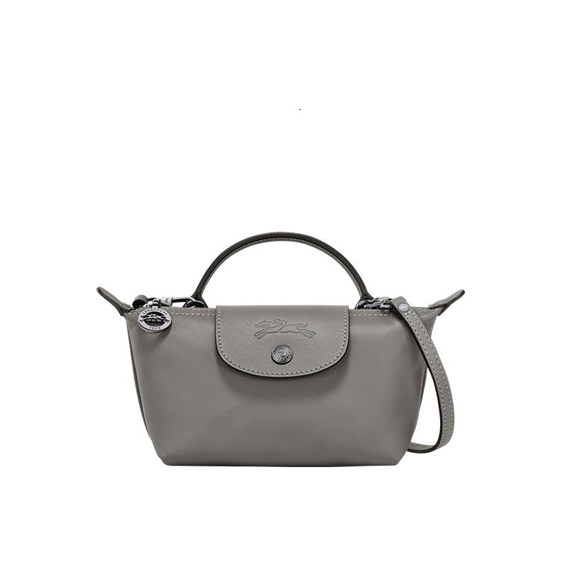 Mini leather tote bag in gray with top handle, shoulder strap, and front flap