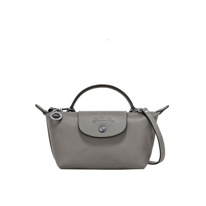 Mini leather tote bag in gray with top handle, shoulder strap, and front flap