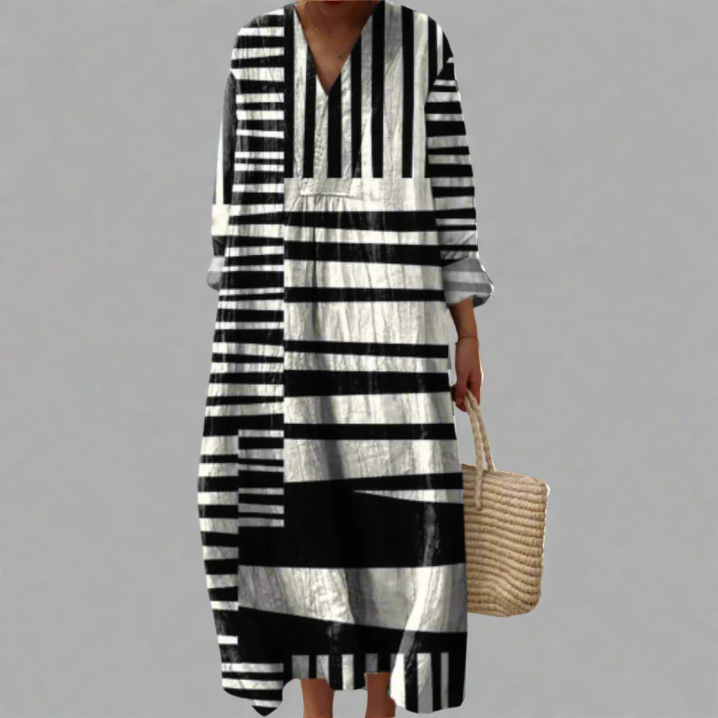 Geometric striped dress with V-neck, black and white bands, tiered midi silhouette