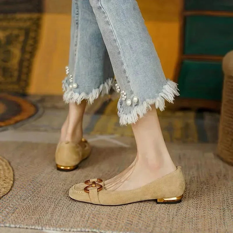 Beige ballet flats with gold chain-link accent and low block heel