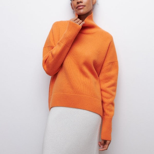 Orange turtleneck knit sweater with ribbed collar, cuffs, and hem.