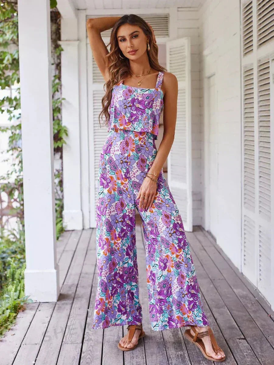 Purple floral wide-leg jumpsuit with square neckline and ruffled bodice.