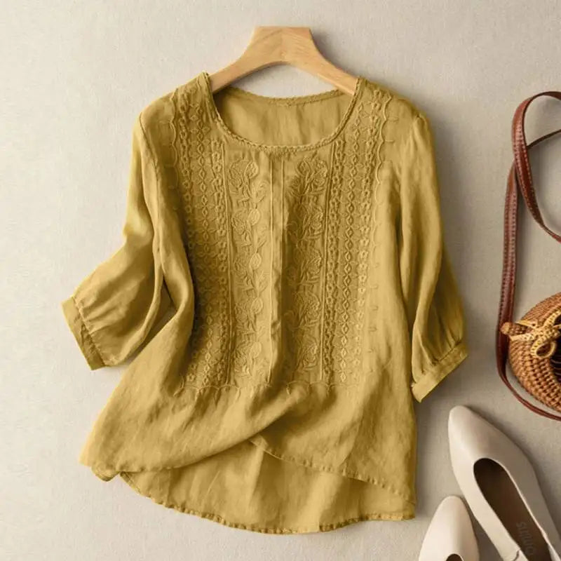 Yellow embroidered blouse with vertical panel detailing and elbow-length puff sleeves