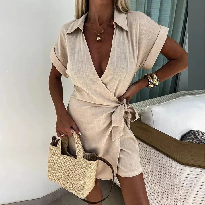 Avery wrap playsuit in beige with V-neck and short sleeves, tied at the waist.