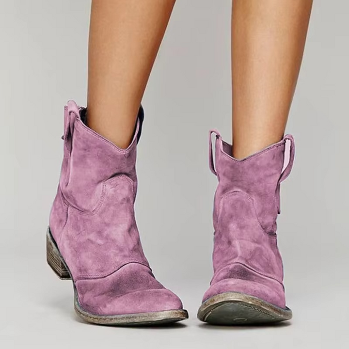 Pink suede western ankle boots with low block heel and pull tabs, pointed toe