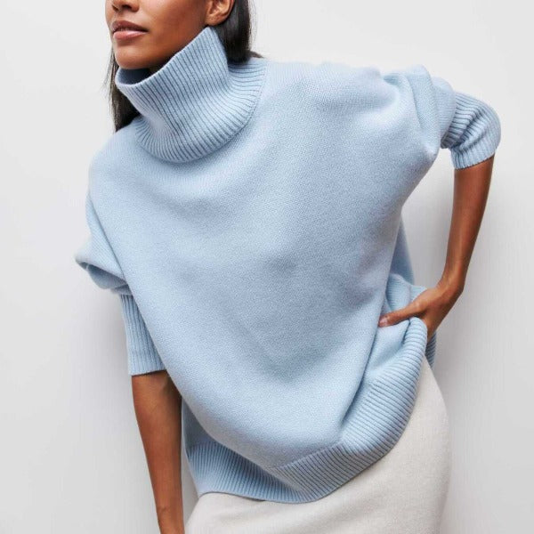 Light blue turtleneck knit sweater with ribbed collar and cuffs.