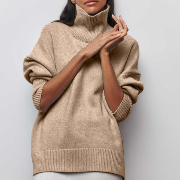 Beige turtleneck knit sweater with ribbed collar and wide cuffs.
