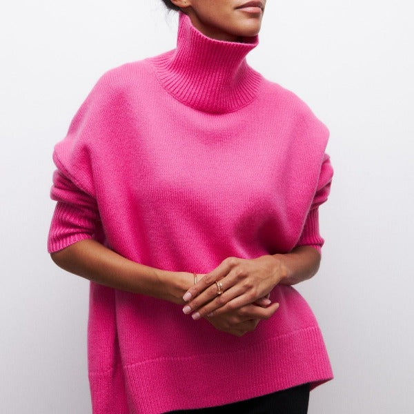 Pink turtleneck knit sweater with ribbed collar and cuffed sleeves.