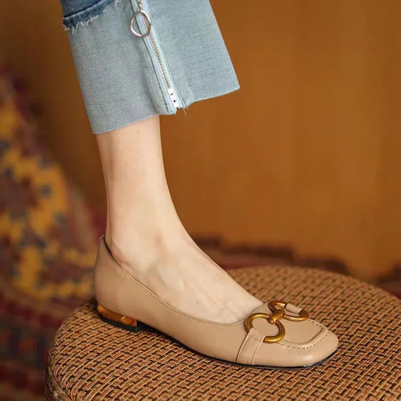Beige ballet flats with gold chain-link detail and low heel