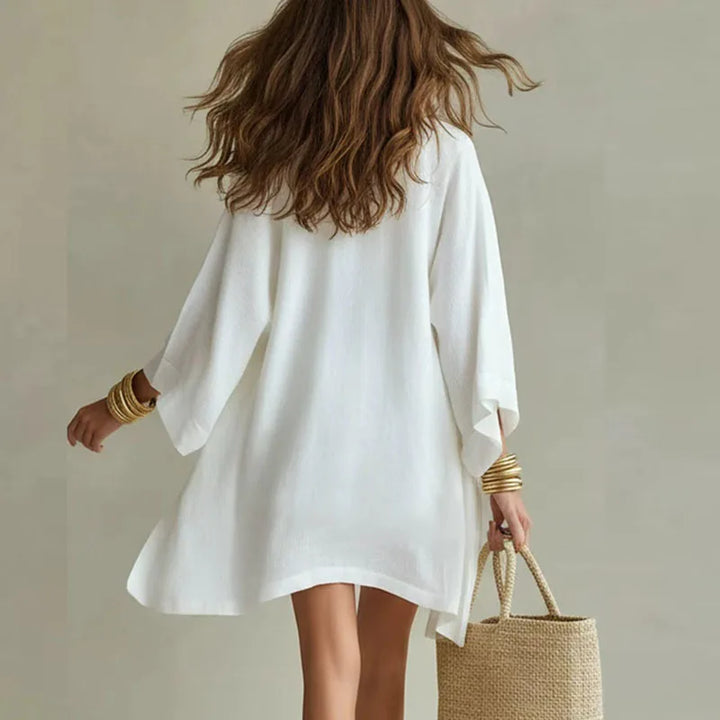 White linen co-ord set with open kimono jacket, swing top, and drawstring shorts.