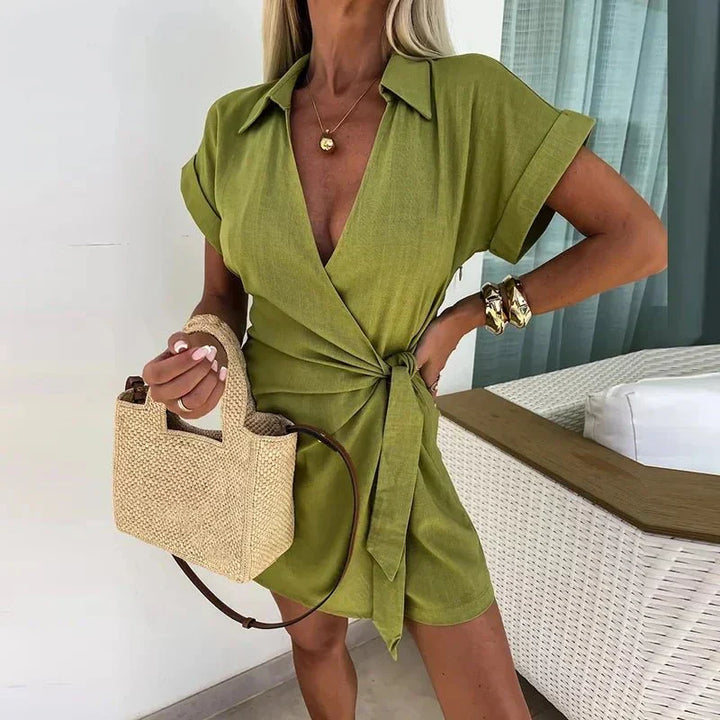 Avery wrap playsuit in green with V-neck, short sleeves, and tie waist detail.