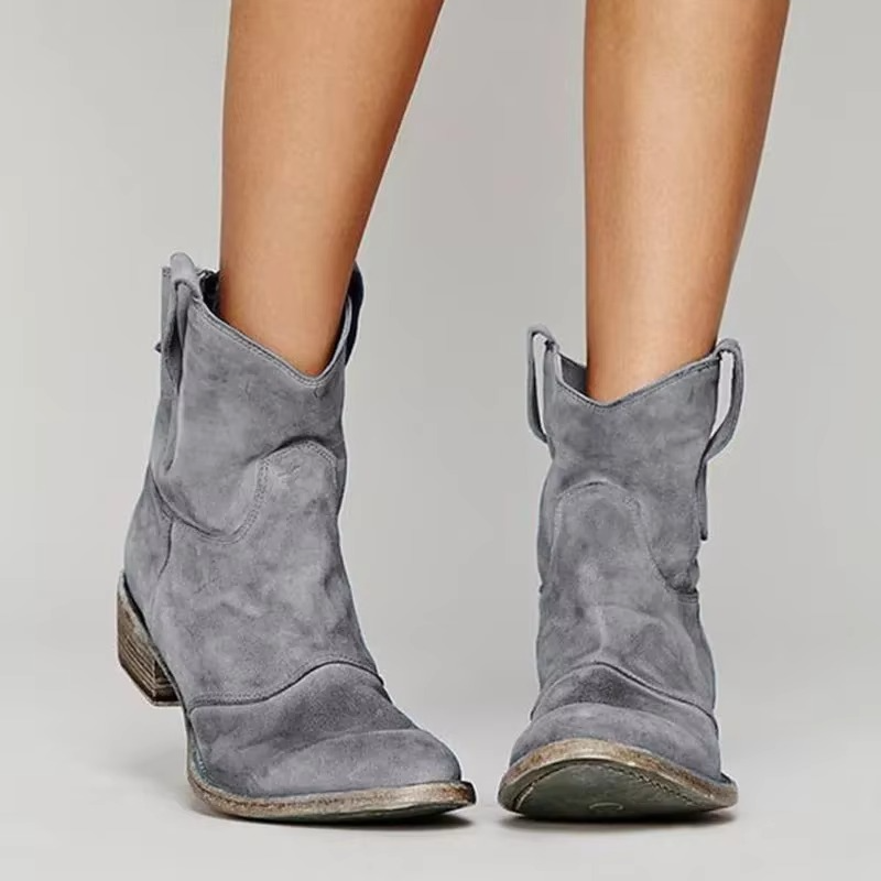 Grey suede western ankle boots with low block heel and pull tabs, pointed toe